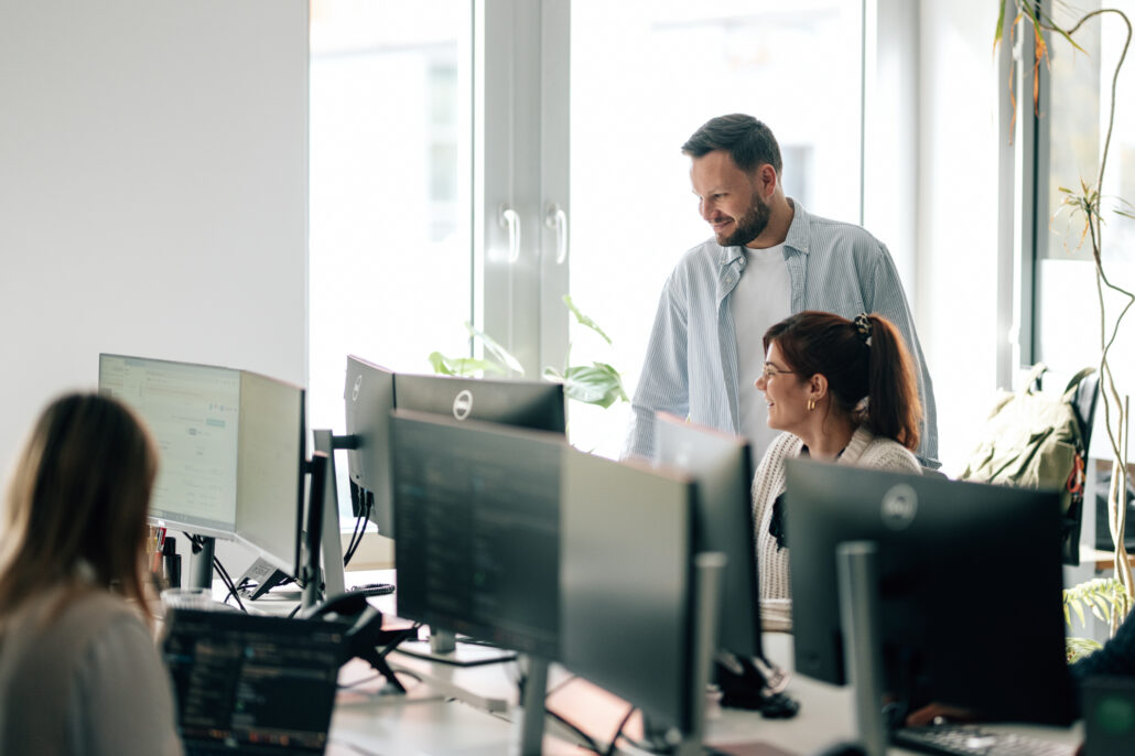 Katja arbeitet zusammen mit Mike an dem Computer.